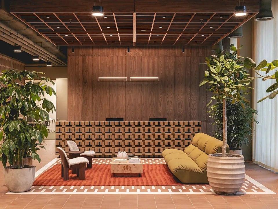 S ofa on a terracotta rug in the reception area with the front desk